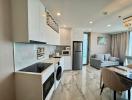 Modern open-plan kitchen with living space, featuring elegant countertops, state-of-the-art appliances, and a comfortable seating area