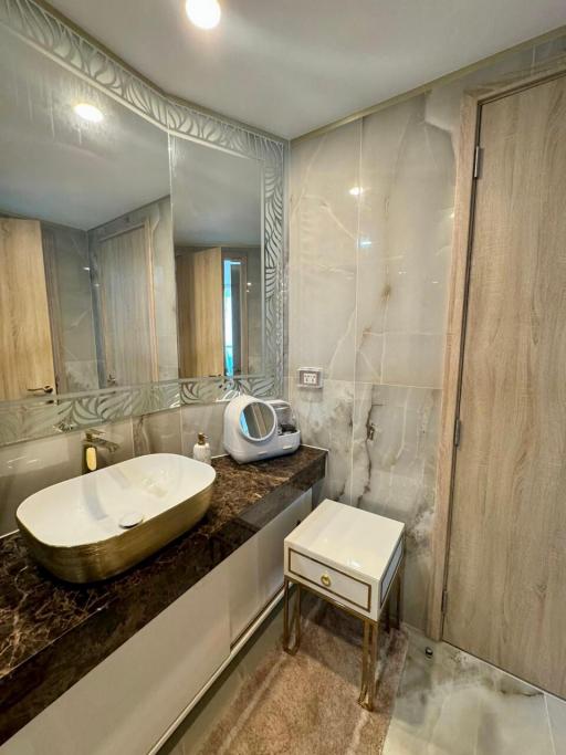 Modern bathroom with wooden cabinets and marble sink