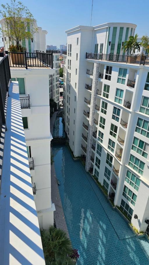 View of a residential building complex featuring a pool