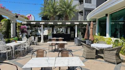 Spacious outdoor patio with seating and lush green plants