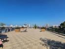 Spacious balcony with city skyline view and outdoor seating