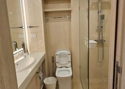 Modern bathroom interior with glass shower and wooden accents