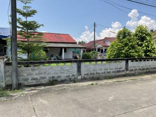 Suburban house behind a concrete fence on a sunny day