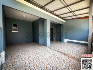 Spacious unfurnished interior of an empty building with tiled flooring and blue walls