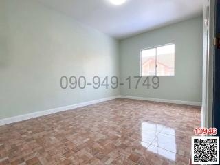 Empty bedroom with parquet flooring and natural light