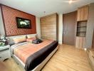 Modern bedroom with wooden flooring and queen-size bed