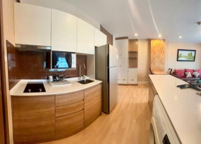 Modern kitchen with stainless steel appliances and wooden cabinetry