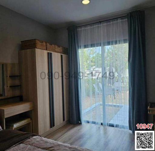Cozy bedroom with wardrobe, study desk, and access to balcony