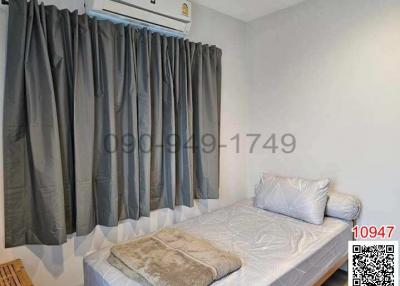Cozy bedroom with air conditioning and large window with grey curtains