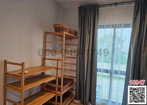 Cozy bedroom with bunk bed, wooden shelves, and large window