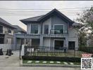 Modern two-story house with gray exterior and balcony