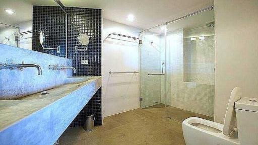 Modern spacious bathroom with double vanity and walk-in shower