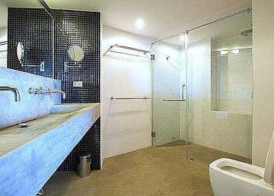 Modern spacious bathroom with double vanity and walk-in shower