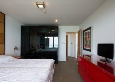 Modern bedroom with ensuite bathroom and balcony access