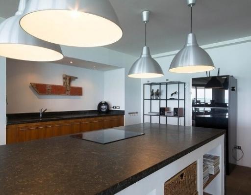 Modern kitchen interior with granite countertops and pendant lights
