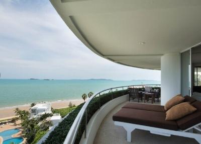Spacious balcony with lounge chair overlooking the beach and ocean