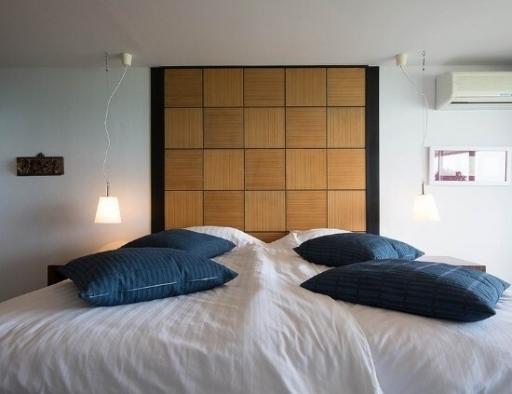 Cozy bedroom with a large bed and modern wooden headboard
