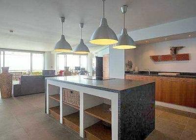 Spacious modern kitchen with central island and open plan living area