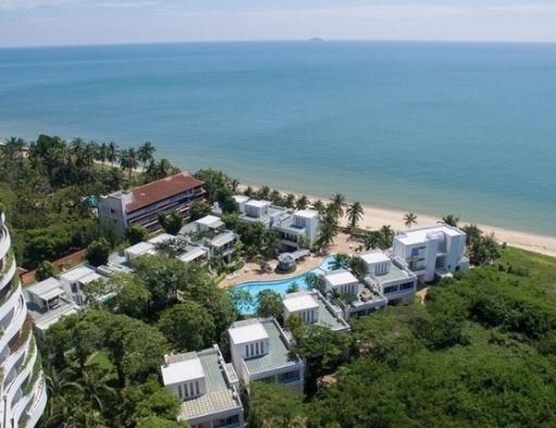 Aerial view of coastal real estate properties with beach access