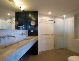 Spacious modern bathroom with walk-in shower and dual sinks