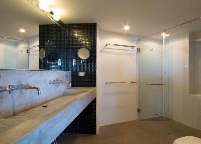 Spacious modern bathroom with walk-in shower and dual sinks