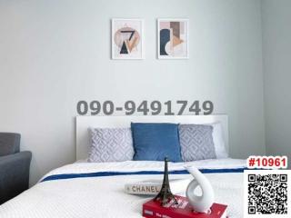 Modern bedroom with art on wall and elegant bedding