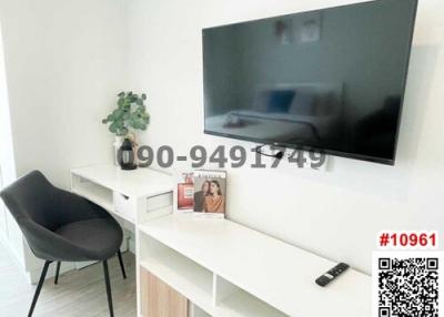 Modern living room with wall-mounted TV and contemporary furniture