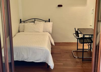 Cozy Bedroom with Hardwood Floors and Modern Amenities