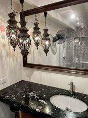 Elegant bathroom with decorative hanging lights and modern fixtures