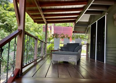 Cozy patio area with comfortable seating and lush greenery around