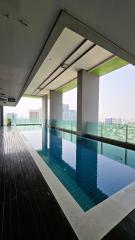 Modern apartment building infinity pool with city skyline view