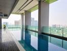 Modern apartment building infinity pool with city skyline view