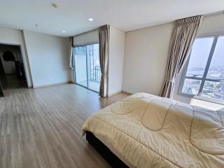 Spacious bedroom with large windows and ample natural light