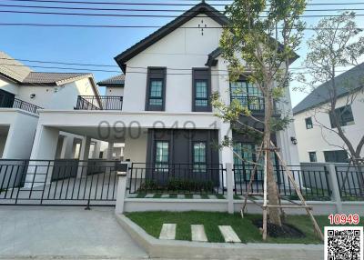 Contemporary two-storey residential house with a landscaped front yard