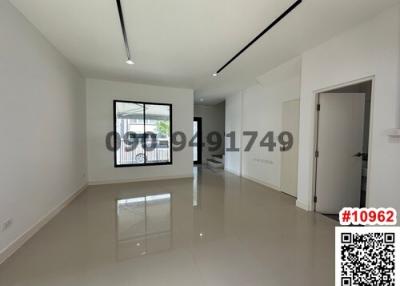Spacious and bright empty living room with glossy tiled flooring and modern light fixtures