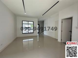 Spacious and bright empty living room with glossy tiled flooring and modern light fixtures