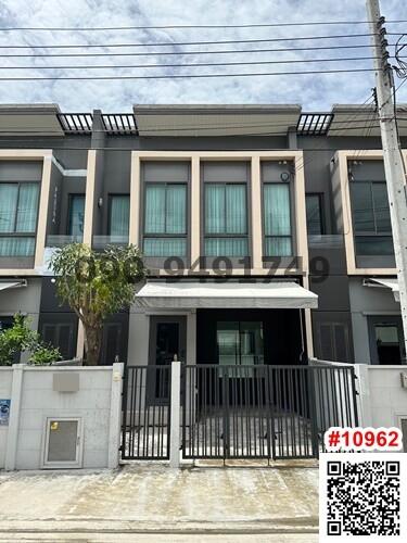 Modern two-story townhouse front exterior with balcony and gate