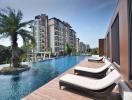 Luxurious outdoor swimming pool with lounging chairs and modern apartment building in the background