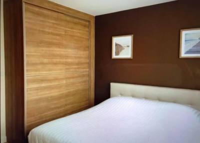 Spacious bedroom with modern wooden wardrobe and cozy double bed