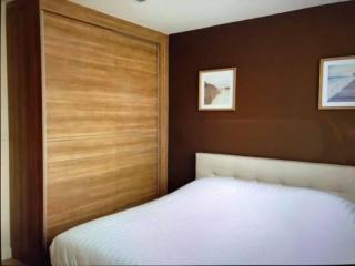 Spacious bedroom with modern wooden wardrobe and cozy double bed