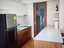 Modern kitchen with wooden cabinets and a large refrigerator