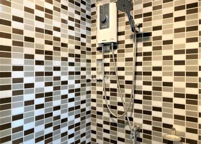 Modern tiled bathroom with electric shower