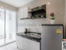 Modern compact kitchen with stainless steel appliances and sliding door