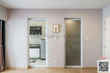 Hallway with view into kitchen and adjacent room