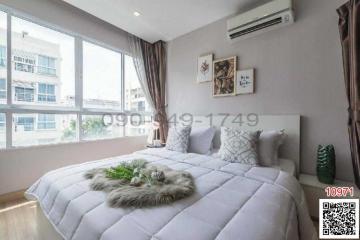 Modern bedroom with natural light and cozy decor