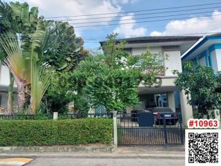 Exterior view of a two-story residential home with lush greenery