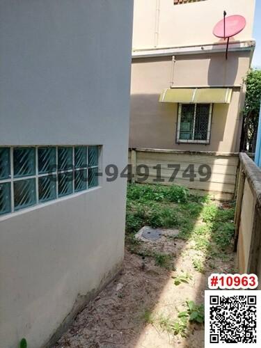 Small side yard space with grass and a satellite dish