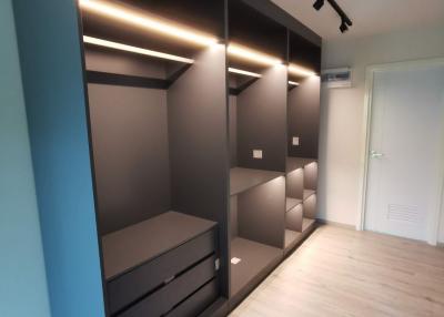 Modern bedroom with built-in wardrobe and lighting