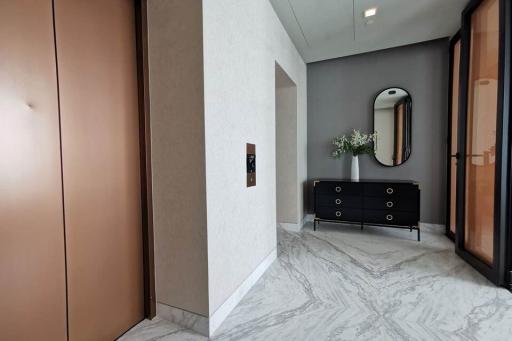 Modern entrance hallway with marble floors and elegant decor