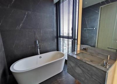 Modern bathroom with freestanding tub and large windows